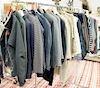 Rack of women's clothing ton include suits and sweaters, by Ralph Lauren, Brunello Cucinelli, Cashmere, Armani, sizes are medium and...