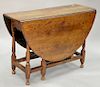 William and Mary oak gateleg oval one drawer table with drop leaves, length 54 inches.