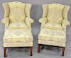 Pair Chippendale style wing chairs with matching ottomans in a yellow and brown upholstery, height to top of back of chairs 42 inche...