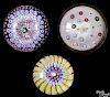 Three antique glass paperweights, to include a concentric millefiori with a central rabbit cane