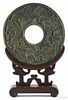 Large Chinese spinach jade disc with relief dragon decoration, the reverse with an incised phoenix
