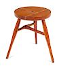* A Modern Stool, c. 20th Century, the circular seat centered by an inset designer logo and raised on three tapering cylindrical