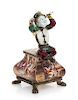 A Continental Enameled Figure, Likely Austrian, Late 19th/Early 20th Century, the figure seated atop the shaped base with enamel