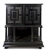 A Neoclassical Ebonized Cabinet on Stand, Height 64 1/4 x width 55 1/4 x depth 20 1/4 inches.