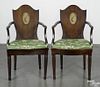 Pair of Italian mahogany shieldback dining chairs, early 19th c., with a hand-painted roundel
