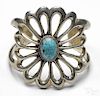 Silver Southwestern style cuff bracelet with open floral design and an oval turquoise cabochon