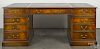 English mahogany desk, 20th c., with a leather inset top, 30'' h., 72 1/2'' w., 42'' d.
