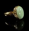 A 14 Karat Yellow Gold and Jadeite Ring Length overall 1 1/8 x width 3/4 inches.