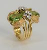 18 karat gold ring, set with two pear shaped green peridot, 6.5 cts. and elegant round brilliant cut diamonds.
size 7, 16.2 grams to...