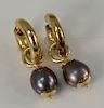 18 karat gold and Mabe pearl earrings having circles and drop pearls, marked: 750.
9.2 grams total weight