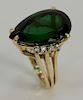 14 karat gold ring, set with large pear shaped green tourmaline, approximately 22 cts., flanked by eight brilliant cut diamonds.
siz...