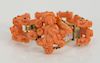 Coral and gold bracelet with carved putti, link carved putti and center putti with fruit, probably 19th century. 
length 6 1/2 inche...