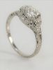 Platinum and diamond ring set with center diamond of approximately .80 cts., in filigree setting. 
size 6