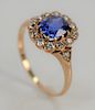 18 karat gold ring, set with blue sapphire of 1.03 cts. surrounded by twelve diamonds flanked by two diamonds.  size 4 3/4