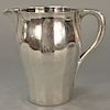 Tiffany & Co. sterling silver hand hammered water pitcher, 
paneled circular form and rolled rim, monogrammed, marked on base: Tiffa...