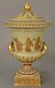 Wedgwood gilt decorated Victoria ware covered urn, 
pale green with gold jeweled ground, gilt relief figures and foliate banded bord...