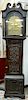 English oak tall clock with carved door and base,  having brass works with brass dial marked: Stratford on Avon, Warwickshire, insid...