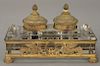 Crystal inkwell with double gilt bronze tops, on crystal block and set in gilt bronze frame with feet (one with ink liner missing). ...