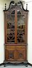 Pair of mahogany two part corner cabinets, 
carved broken arch tops over double arch top doors, on lower section with one drawer and...