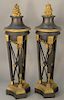 Pair of gilt and bronze torcheres having flame tops on supported stands with paw feet on gilt bronze base on bronze (in three parts)...