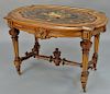 Renaissance Revival walnut center table having inlaid inset top, set on turned and fluted legs (minor imperfections to top). 
height...