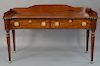 Sheraton mahogany sideboard with gallery back and sides, 
having two drawers set on fluted legs, ending in brass paw feet, circa 183...