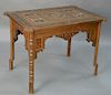 Mid-Eastern table of various woods and mother of pearl inlays in stars and geometric forms, set on square inlaid legs.  height 28...