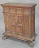 Continental carved walnut commode, 
possibly late 17th century, with later elements, short drawer over paneled cupboard doors, on pa...
