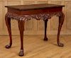 MAHOGANY TEA TABLE IN THE GEORGIAN STYLE CARVED