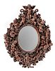 An Italian Renaissance Revival Carved Walnut Mirror Height 61 x width 45 inches.