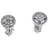 A diamond 14K and 10K white gold pait of stud earrings.