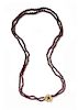 * A Graduated Double Strand Garnet Bead Necklace,