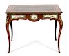 A Louis XV Style Gilt Bronze and Sevres Style Porcelain Mounted Writing Table Height 29 x width 37 x depth 22 1/2 inches.