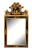 A George I Style Carved Parcel Gilt and Japanned Wall Mirror Height 64 x width 32 1/2 inches.