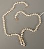 Pearl necklace with 14 karat clasp and 14 karat pendant set with light blue stone.