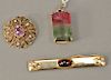 Three piece lot to include an 18 karat gold pendant set with watermelon color stone and three small diamonds 15.5 x 27.5mm and two pins: a round pin w