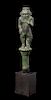 * An Egyptian Bronze Bes Standing on a Papyrus Umbel Height 7 inches.
