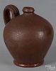 Small redware ovoid jug, 19th c., 5 1/4'' h. Provenance: R. H. Wood.