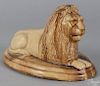 Yelloware figure of a recumbent lion, late 19th c., with its tail curled to the side