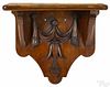Pennsylvania carved walnut shelf, late 19th c., with applied tulip and swag, 12'' h., 14'' w.