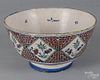 Bristol or London Delft tin glazed earthenware punch bowl, mid 18th c., with floral diamond panels