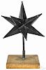 Painted tin Moravian star, 19th c., retaining an old black surface, with a stand, 20 1/2'' h.