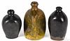 Three redware bottles, 19th c., to include one pinch bottle with a mottled green and orange glaze