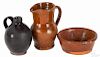 Three miniature pieces of redware, 19th c., to include a pitcher, 3'' h., an ovoid jug, 2 1/2'' h.