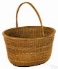 Nantucket lightship basket, early 20th c., with a swing handle, 8 1/4'' h., 13 1/2'' w.