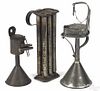 Group of tin lighting, 19th c., to include a fat lamp on a stand, 13 1/4'' h.