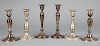 Three pairs of weighted sterling silver candlesticks