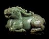* A Celadon Jade Figure of a Recumbent Qilin Height 11 inches.