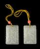 A Pair of White Jade 'Dragon and Phoenix' Plaques Length of each 2 1/4 inches.