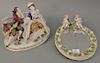 Two piece lot to include German porcelain figural group (ht. 8 1/2 in., lg. 12 in.) and oval mirror with putti figures (12 1/2" x 10").